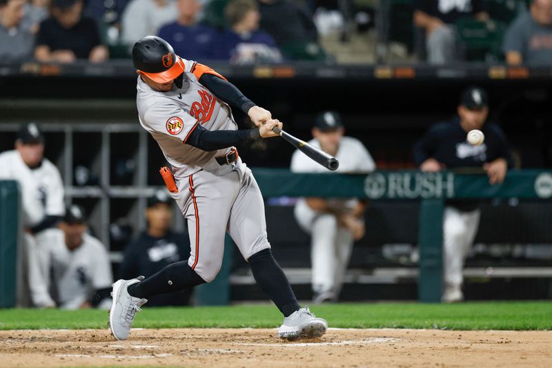 May 23, 2024; Chicago, Illinois, USA; Baltimore Orioles outfielder Austin Hays (21) hits a RBI-single against the Chicago White Sox during the sixth inning at Guaranteed Rate Field. Mandatory Credit: Kamil Krzaczynski-USA TODAY Sports