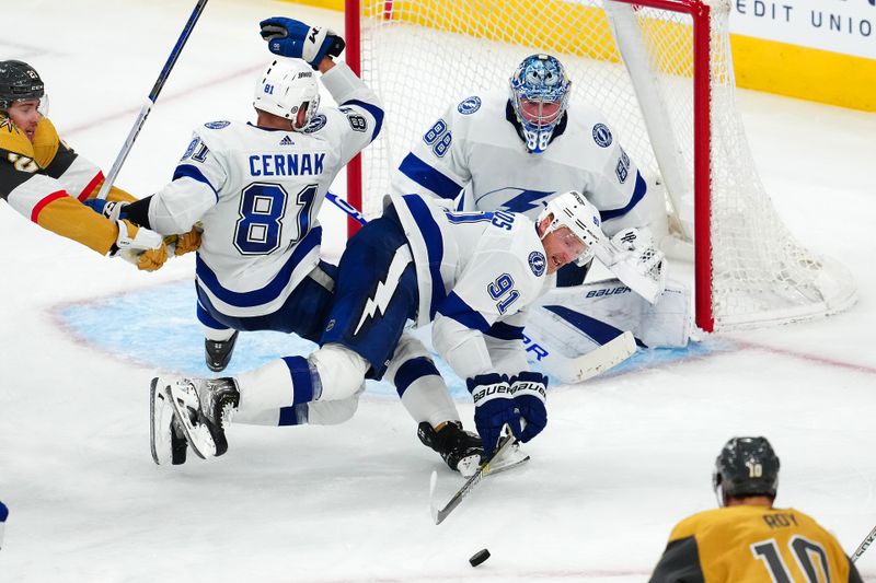 Mar 19, 2024; Las Vegas, Nevada, USA; Tampa Bay Lightning center Steven Stamkos (91) attempts to clear the puck in front of Tampa Bay Lightning defenseman Erik Cernak (81) as Tampa Bay Lightning goaltender Andrei Vasilevskiy (88) defends his net against the Vegas Golden Knights during the third period at T-Mobile Arena. Mandatory Credit: Stephen R. Sylvanie-USA TODAY Sports