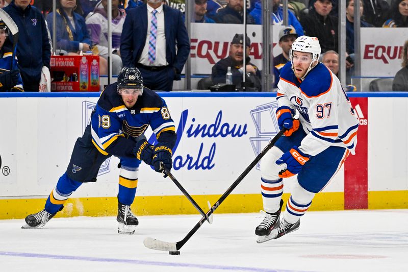 Feb 15, 2024; St. Louis, Missouri, USA;  Edmonton Oilers center Connor McDavid (97) controls the puck as St. Louis Blues left wing Pavel Buchnevich (89) defends during the first period at Enterprise Center. Mandatory Credit: Jeff Curry-USA TODAY Sports