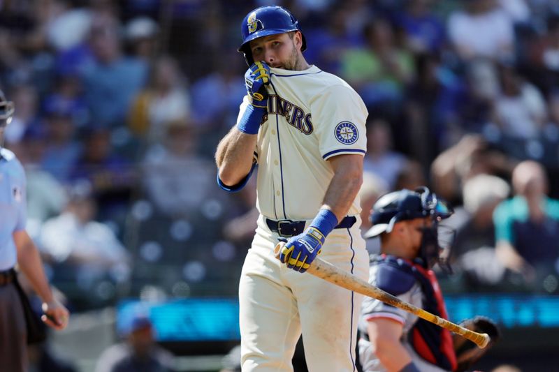 Jun 30, 2024; Seattle, Washington, USA; Seattle Mariners catcher Cal Raleigh (29) wipes his face as he walks to the dugout after striking out against the Minnesota Twins during the ninth inning at T-Mobile Park. Mandatory Credit: John Froschauer-USA TODAY Sports