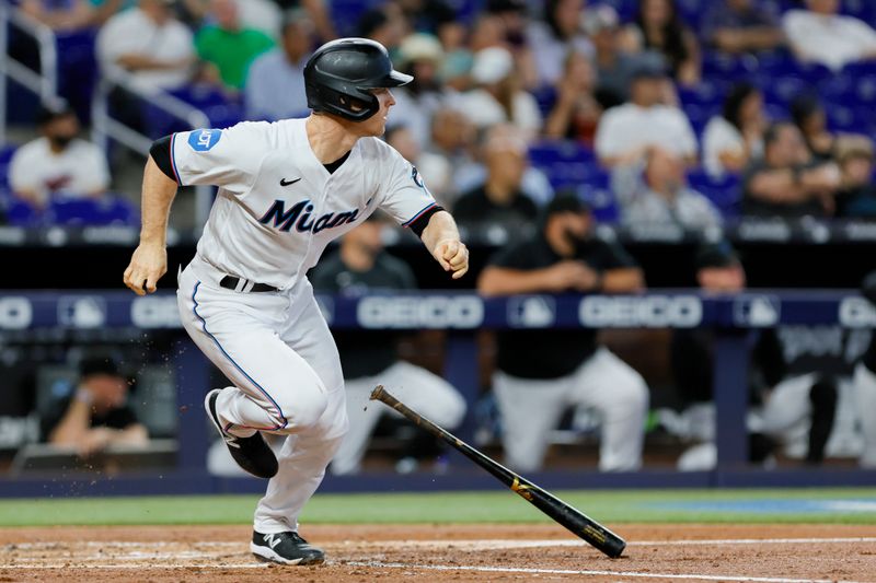 Jun 21, 2023; Miami, Florida, USA; Miami Marlins shortstop Joey Wendle (18) hits a single against the Toronto Blue Jays during the second inning at loanDepot Park. Mandatory Credit: Sam Navarro-USA TODAY Sports