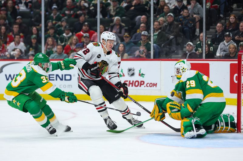 Dec 3, 2023; Saint Paul, Minnesota, USA; Minnesota Wild goaltender Marc-Andre Fleury (29) blocks a shot by Chicago Blackhawks defenseman Alex Vlasic (72) while Minnesota Wild defenseman Alex Goligoski (33) defends during the first period at Xcel Energy Center. Mandatory Credit: Matt Krohn-USA TODAY Sports