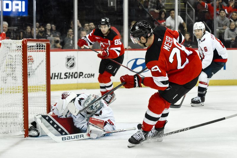 Oct 19, 2024; Newark, New Jersey, USA; Washington Capitals goaltender Logan Thompson (48) makes a save against New Jersey Devils right wing Timo Meier (28) during the overtime period at Prudential Center. Mandatory Credit: John Jones-Imagn Images