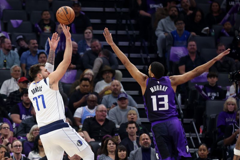 SACRAMENTO, CALIFORNIA - MARCH 26: Luka Doncic #77 of the Dallas Mavericks shoots over Keegan Murray #13 of the Sacramento Kings in the first half at Golden 1 Center on March 26, 2024 in Sacramento, California. NOTE TO USER: User expressly acknowledges and agrees that, by downloading and or using this photograph, User is consenting to the terms and conditions of the Getty Images License Agreement.  (Photo by Ezra Shaw/Getty Images)