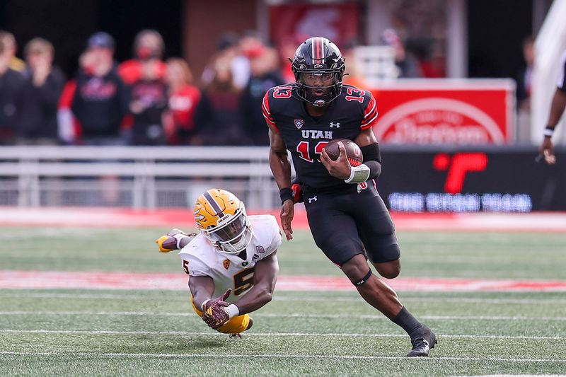 Nov 4, 2023; Salt Lake City, Utah, USA; Utah Utes quarterback Nate Johnson (13) breaks a tackle by Arizona State Sun Devils defensive back Chris Edmonds (5) in the fourth quarter at Rice-Eccles Stadium. Mandatory Credit: Rob Gray-USA TODAY Sports