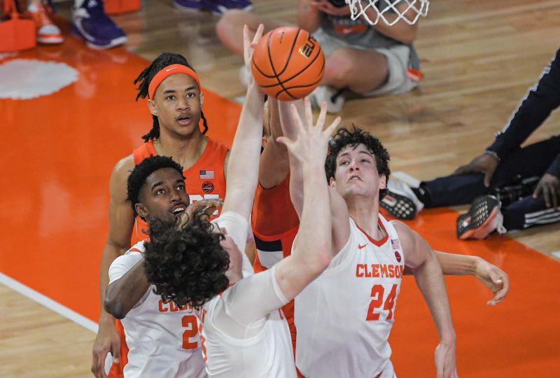 Feb 22, 2023; Clemson, South Carolina, USA; Clemson forward PJ Hall (24) and forward Ian Schieffelin (4) rebound against Syracuse forward Maliq Brown (1) during the first half at Littlejohn Coliseum. Mandatory Credit: Ken Ruinard-USA TODAY Sports