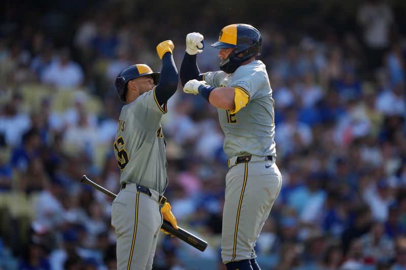 Jul 6, 2024; Los Angeles, California, USA; Milwaukee Brewers first baseman Rhys Hoskins (12) celebrates with center fielder Blake Perkins (16) after hitting a home run in the fourth inning against the Los Angeles Dodgers at Dodger Stadium. Mandatory Credit: Kirby Lee-USA TODAY Sports