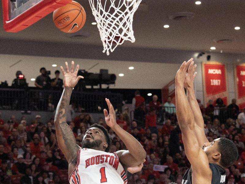 Jan 28, 2023; Houston, Texas, USA; Houston Cougars guard Jamal Shead (1) shoots against Cincinnati Bearcats guard David DeJulius (5) in the first half at Fertitta Center. Mandatory Credit: Thomas Shea-USA TODAY Sports