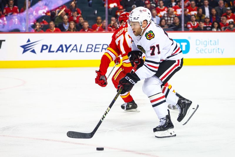 Oct 15, 2024; Calgary, Alberta, CAN; Chicago Blackhawks left wing Taylor Hall (71) controls the puck against the Calgary Flames during the first period at Scotiabank Saddledome. Mandatory Credit: Sergei Belski-Imagn Images