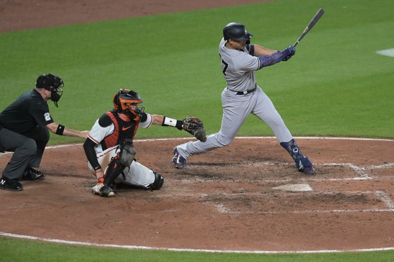 Jul 29, 2023; Baltimore, Maryland, USA;  New York Yankees designated hitter Giancarlo Stanton (27) singles during the sixth inning against the Baltimore Orioles at Oriole Park at Camden Yards. Mandatory Credit: Tommy Gilligan-USA TODAY Sports