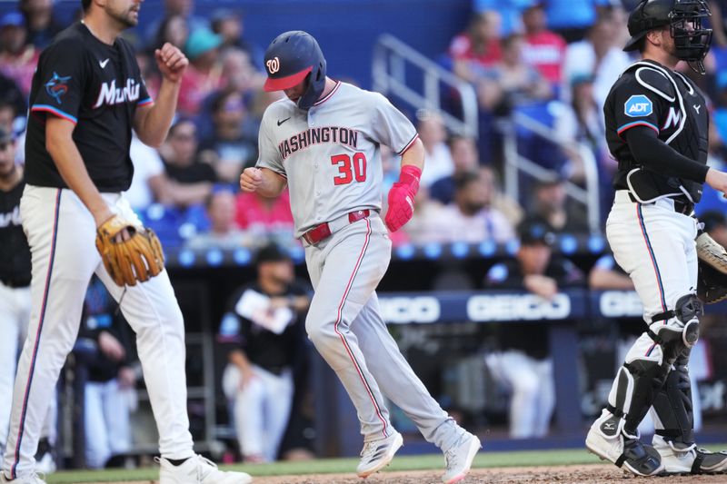 Apr 12, 2025; Miami, Florida, USA;  Washington Nationals center fielder Jacob Young (30) scores a run in the seventh inning against the Miami Marlins at loanDepot Park. Mandatory Credit: Jim Rassol-Imagn Images