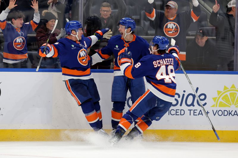 Feb 3, 2026; Elmont, New York, USA; New York Islanders center Bo Horvat (14) celebrates his game winning overtime goal against the Pittsburgh Penguins with center Mathew Barzal (13) and defenseman Matthew Schaefer (48) at UBS Arena. Mandatory Credit: Brad Penner-Imagn Images