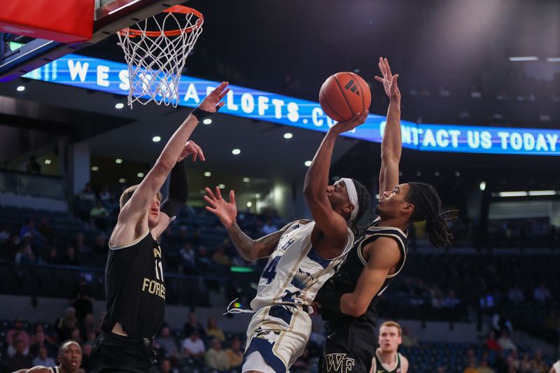 Feb 6, 2024; Atlanta, Georgia, USA; Georgia Tech Yellow Jackets guard Amaree Abram (24) shoots past Wake Forest Demon Deacons forward Andrew Carr (11) and guard Hunter Sallis (23) in the second half at McCamish Pavilion. Mandatory Credit: Brett Davis-USA TODAY Sports
