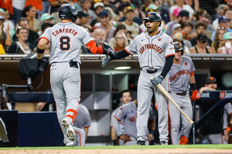 Sep 6, 2024; San Diego, California, USA; San Francisco Giants designated hitter Michael Conforto (8) celebrates with San Francisco Giants first baseman LaMonte Wade Jr. (31) after hitting a one run home run during the sixth inning against the San Diego Padres at Petco Park. Mandatory Credit: David Frerker-Imagn Images