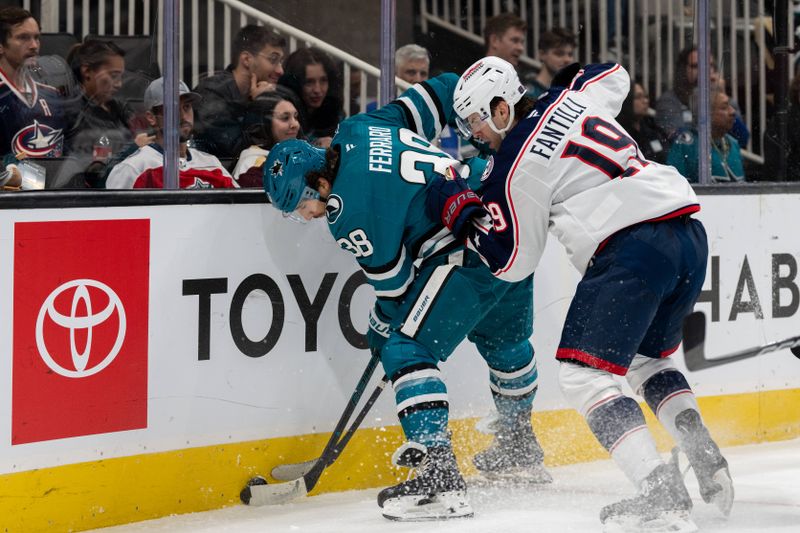 Nov 5, 2024; San Jose, California, USA;  San Jose Sharks defenseman Mario Ferraro (38) and Columbus Blue Jackets center Adam Fantilli (19) battle for the puck behind the net during the first period at SAP Center at San Jose. Mandatory Credit: Neville E. Guard-Imagn Images