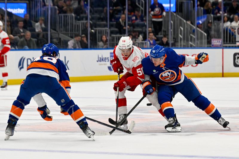 Oct 23, 2025; Elmont, New York, USA;  New York Islanders defenseman Matthew Schaefer (48) and New York Islanders center Kyle MacLean (32) defend against Detroit Red Wings center Emmitt Finnie (58) during the first period at UBS Arena. Mandatory Credit: Dennis Schneidler-Imagn Images