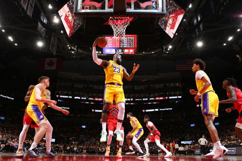 TORONTO, CANADA - NOVEMBER 1: LeBron James #23 of the Los Angeles Lakers grabs the rebound during the game against the Toronto Raptors on November 1, 2024 at the Scotiabank Arena in Toronto, Ontario, Canada.  NOTE TO USER: User expressly acknowledges and agrees that, by downloading and or using this Photograph, user is consenting to the terms and conditions of the Getty Images License Agreement.  Mandatory Copyright Notice: Copyright 2024 NBAE (Photo by Vaughn Ridley/NBAE via Getty Images)