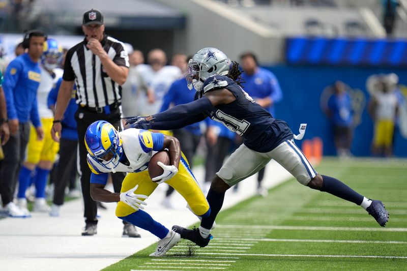 Los Angeles Rams wide receiver Xavier Smith, left, is pushed out of bounds by Dallas Cowboys cornerback Caelen Carson (41) afer Smith caught a pass during the first half of a preseason NFL football game, Sunday, Aug. 11, 2024, in Inglewood, Calif. (AP Photo/Gregory Bull)