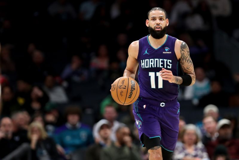 CHARLOTTE, NORTH CAROLINA - FEBRUARY 12: Cody Martin #11 of the Charlotte Hornets brings the ball down the court during the first half of an NBA game against the Indiana Pacers at Spectrum Center on February 12, 2024 in Charlotte, North Carolina. NOTE TO USER: User expressly acknowledges and agrees that, by downloading and or using this photograph, User is consenting to the terms and conditions of the Getty Images License Agreement. (Photo by David Jensen/Getty Images)