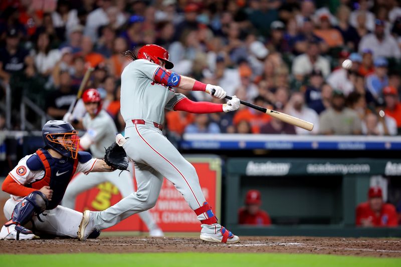 Jun 26, 2025; Houston, Texas, USA; Philadelphia Phillies center fielder Brandon Marsh (16) hits an RBI sacrifice fly against the Houston Astros during the eighth inning at Daikin Park. Mandatory Credit: Erik Williams-Imagn Images