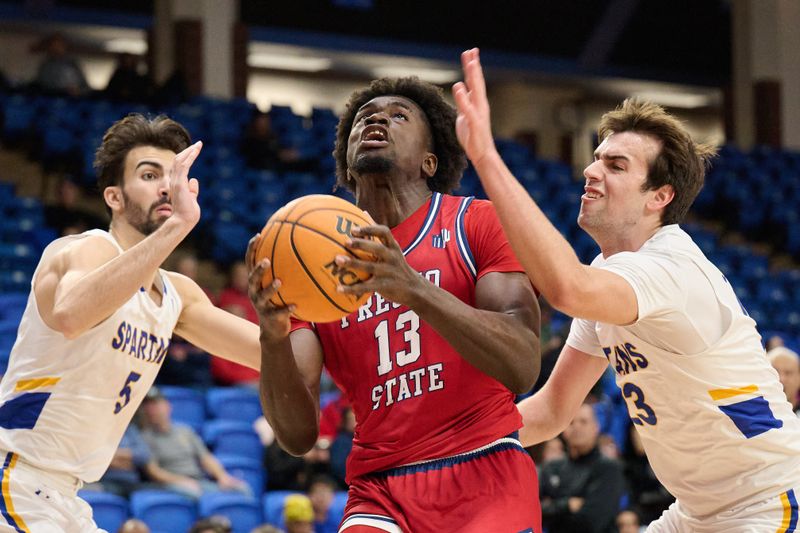 Feb 6, 2024; San Jose, California, USA; Fresno State Bulldogs center Enoch Boakye (13) controls the ball against San Jose State Spartans forward Tibet Gorener (5) and forward Diogo Seixas (23)during the first half at Provident Credit Union Event Center. Mandatory Credit: Robert Edwards-USA TODAY Sports