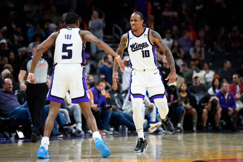 PHOENIX, ARIZONA - NOVEMBER 10: De'Aaron Fox #5 of the Sacramento Kings celebrates with teammate DeMar DeRozan #10 after scoring in overtime against the Phoenix Suns at Footprint Center on November 10, 2024 in Phoenix, Arizona. NOTE TO USER: User expressly acknowledges and agrees that, by downloading and/or using this photograph, user is consenting to the terms and conditions of the Getty Images License Agreement.  (Photo by Kelsey Grant/Getty Images)