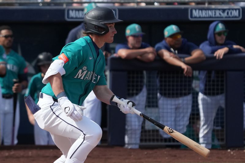 Feb 26, 2026; Peoria, Arizona, USA; Seattle Mariners shortstop Colt Emerson (85) hits a single against the Cleveland Guardians in the second inning at Peoria Sports Complex. Mandatory Credit: Rick Scuteri-Imagn Images