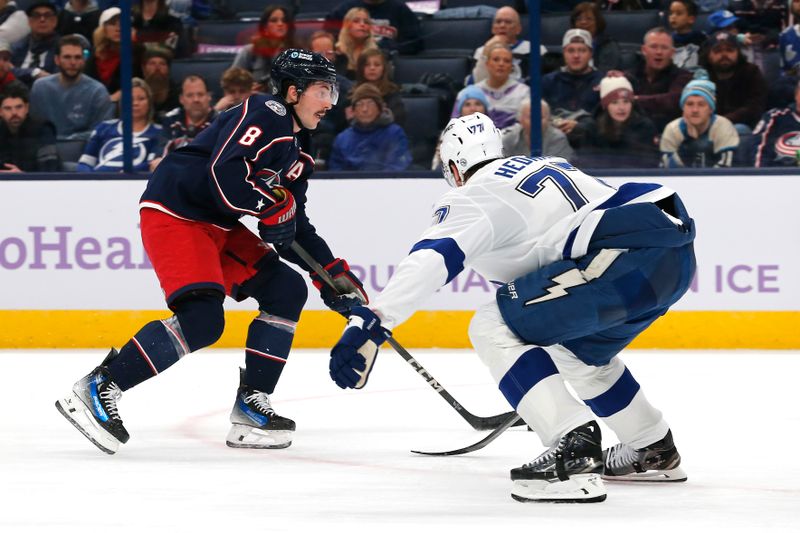 Nov 21, 2024; Columbus, Ohio, USA; Columbus Blue Jackets defenseman Zach Werenski (8) carries the puck as Tampa Bay Lightning defenseman Victor Hedman (77) defends during the second period at Nationwide Arena. Mandatory Credit: Russell LaBounty-Imagn Images