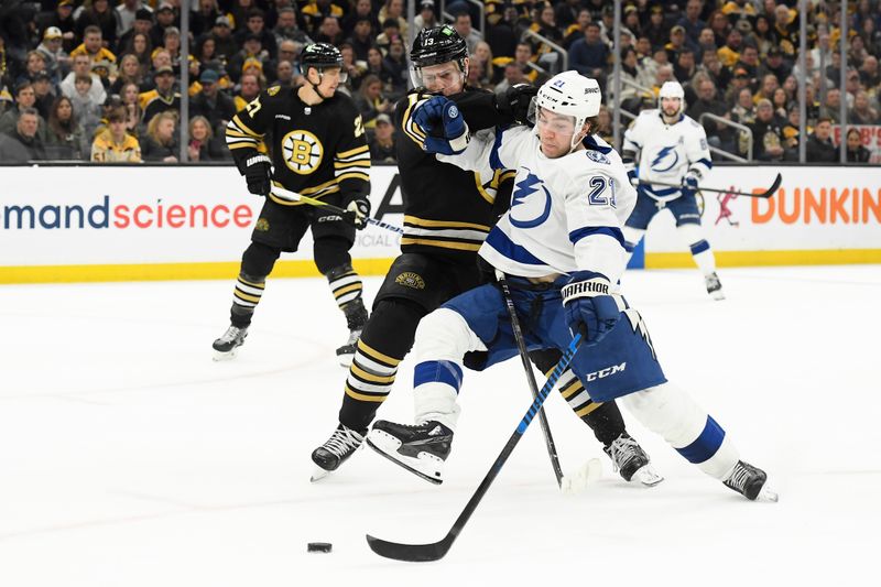 Feb 13, 2024; Boston, Massachusetts, USA;  Tampa Bay Lightning center Brayden Point (21) tries to fend off Boston Bruins center Charlie Coyle (13) during the third period at TD Garden. Mandatory Credit: Bob DeChiara-USA TODAY Sports