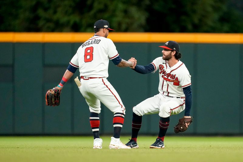 Oct 12, 2022; Atlanta, Georgia, USA; Atlanta Braves left fielder Eddie Rosario (8) helps up teammate shortstop Dansby Swanson (7) in the game against the Philadelphia Phillies in the sixth inning during game two of the NLDS for the 2022 MLB Playoffs at Truist Park. Mandatory Credit: Dale Zanine-USA TODAY Sports