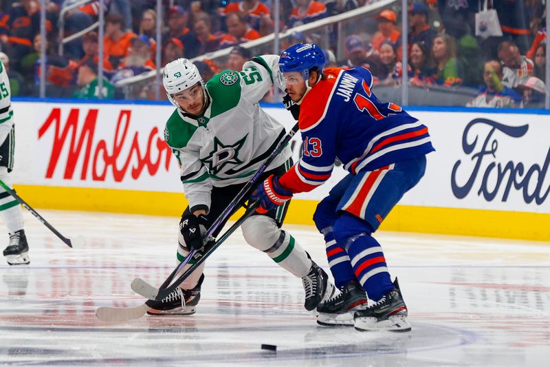 May 27, 2025; Edmonton, Alberta, CAN; Dallas Stars center Wyatt Johnston (53) and Edmonton Oilers center Mattias Janmark (13) battle for control of the puck during the second period in game four of the Western Conference Final of the 2025 Stanley Cup Playoffs at Rogers Place. Mandatory Credit: Perry Nelson-Imagn Images
