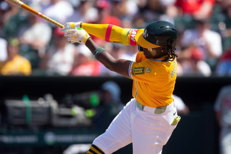 May 25, 2025; West Sacramento, California, USA; Athletics right fielder Lawrence Butler (4) follows through on his RBI triple against the Philadelphia Phillies during the ninth inning at Sutter Health Park. Mandatory Credit: D. Ross Cameron-Imagn Images