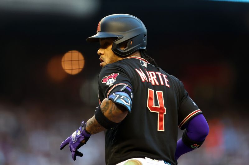 Oct 31, 2023; Phoenix, Arizona, USA; Arizona Diamondbacks second baseman Ketel Marte (4) reacts after hitting a single against the Texas Rangers during the first inning in game four of the 2023 World Series at Chase Field. Mandatory Credit: Mark J. Rebilas-USA TODAY Sports