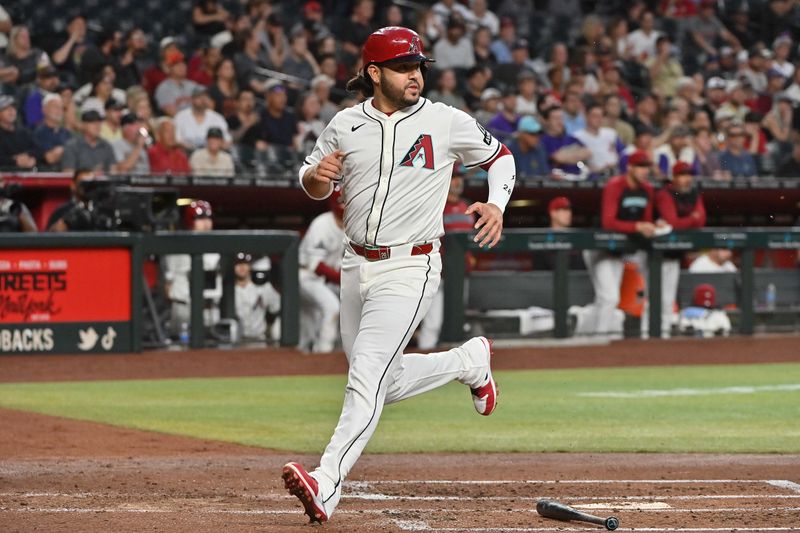 Apr 24, 2025; Phoenix, Arizona, USA;  Arizona Diamondbacks third base Eugenio Suárez (28) scores in the second inning against the Tampa Bay Rays at Chase Field. Mandatory Credit: Matt Kartozian-Imagn Images
