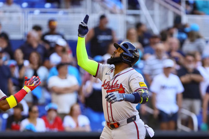 Apr 14, 2024; Miami, Florida, USA; Atlanta Braves designated hitter Marcell Ozuna (20) reacts as he scores after hitting a two-run home run against the Miami Marlins during the ninth inning at loanDepot Park. Mandatory Credit: Sam Navarro-USA TODAY Sports