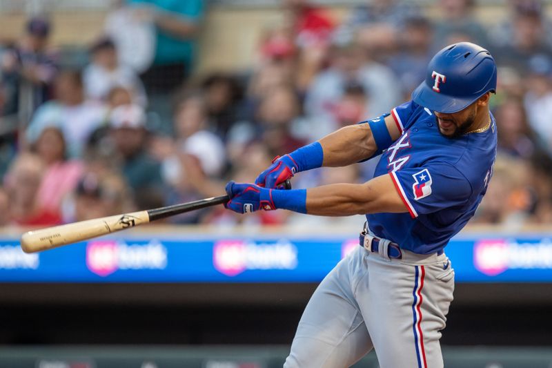 Aug 24, 2023; Minneapolis, Minnesota, USA; Texas Rangers center fielder Leody Taveras (3) hits a solo home run against the Minnesota Twins in the fourth inning at Target Field. Mandatory Credit: Jesse Johnson-USA TODAY Sports