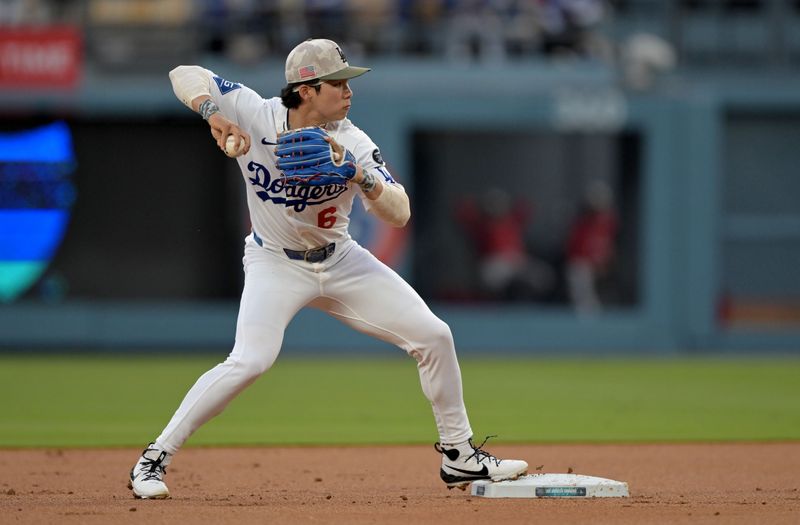 May 16, 2025; Los Angeles, California, USA; Los Angeles Dodgers second baseman Hyeseong Kim (6) turns a double play during the first inning against the Los Angeles Angels at Dodger Stadium. Mandatory Credit: Jayne Kamin-Oncea-Imagn Images