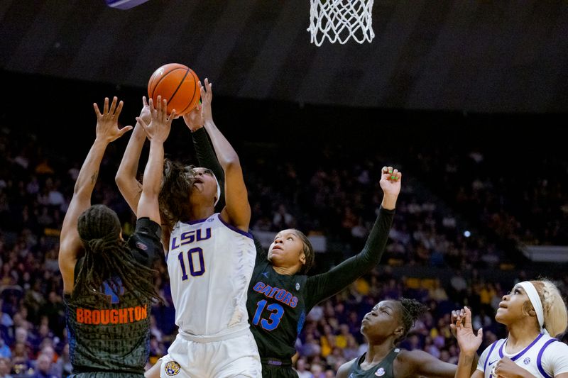 Feb 4, 2024; Baton Rouge, Louisiana, USA; LSU Lady Tigers forward Angel Reese (10) shoots against Florida Gators guard Zippy Broughton (4) and guard Laila Reynolds (13) during the first half at Pete Maravich Assembly Center. Mandatory Credit: Matthew Hinton-USA TODAY Sports