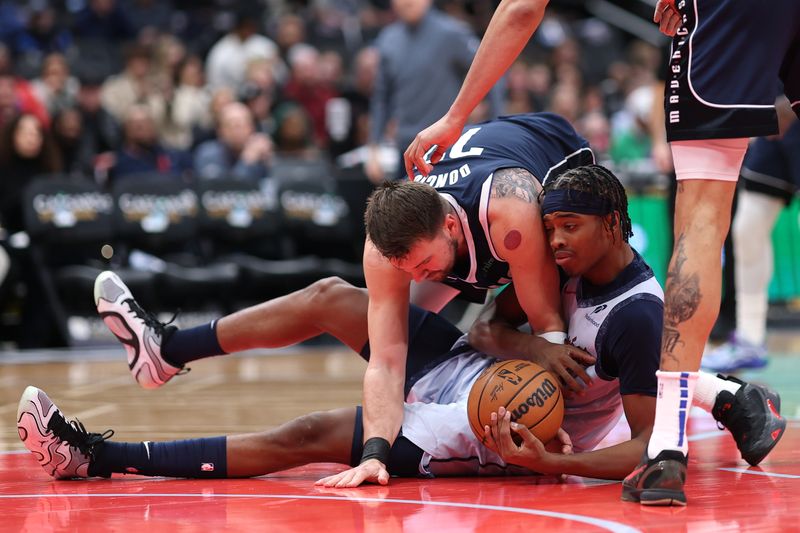 WASHINGTON, DC - DECEMBER 05: Bilal Coulibaly #0 of the Washington Wizards and Luka Doncic #77 of the Dallas Mavericks battle for a loose ball during the first half at Capital One Arena on December 05, 2024 in Washington, DC. NOTE TO USER: User expressly acknowledges and agrees that, by downloading and or using this photograph, User is consenting to the terms and conditions of the Getty Images License Agreement. (Photo by Patrick Smith/Getty Images)