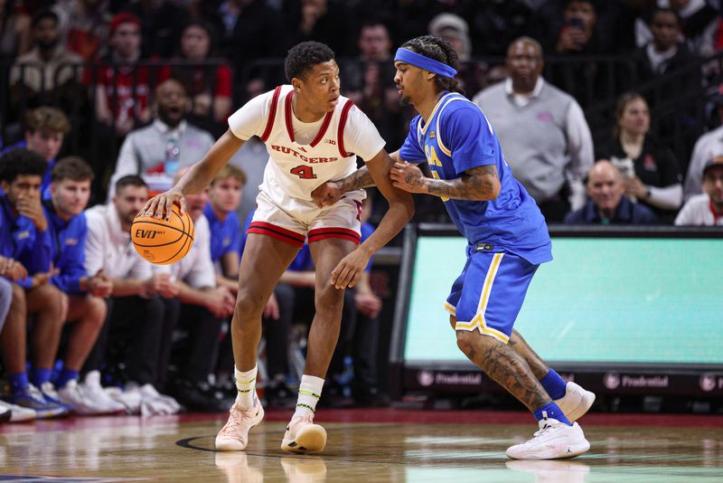 Jan 13, 2025; Piscataway, New Jersey, USA; Rutgers Scarlet Knights guard Ace Bailey (4) is guarded by UCLA Bruins guard Skyy Clark (55)  during the first half at Jersey Mike's Arena. Mandatory Credit: Vincent Carchietta-Imagn Images