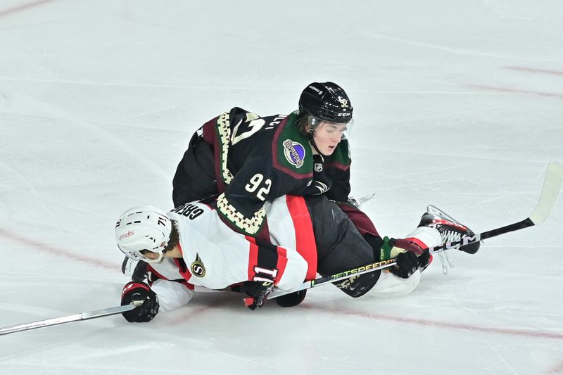 Dec 19, 2023; Tempe, Arizona, USA; Arizona Coyotes center Logan Cooley (92) and Ottawa Senators center Ridly Greig (71) wrestle in the third period at Mullett Arena. Mandatory Credit: Matt Kartozian-USA TODAY Sports