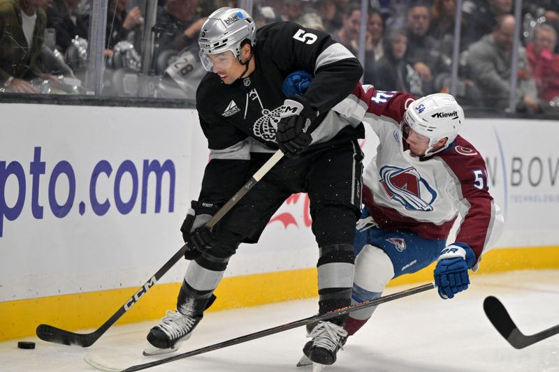 Oct 7, 2025; Los Angeles, California, USA;  Los Angeles Kings defenseman Cody Ceci (5) and Colorado Avalanche center Gavin Brindley (54) battle along the boards during the first period at Crypto.com Arena. Mandatory Credit: Jayne Kamin-Oncea-Imagn Images