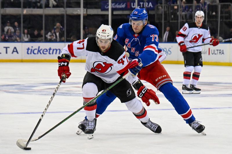 Oct 2, 2025; New York, New York, USA;  New York Rangers center Matt Rempe (73) defends against New Jersey Devils left wing Paul Cotter (47) during the third period at Madison Square Garden. Mandatory Credit: Dennis Schneidler-Imagn Images