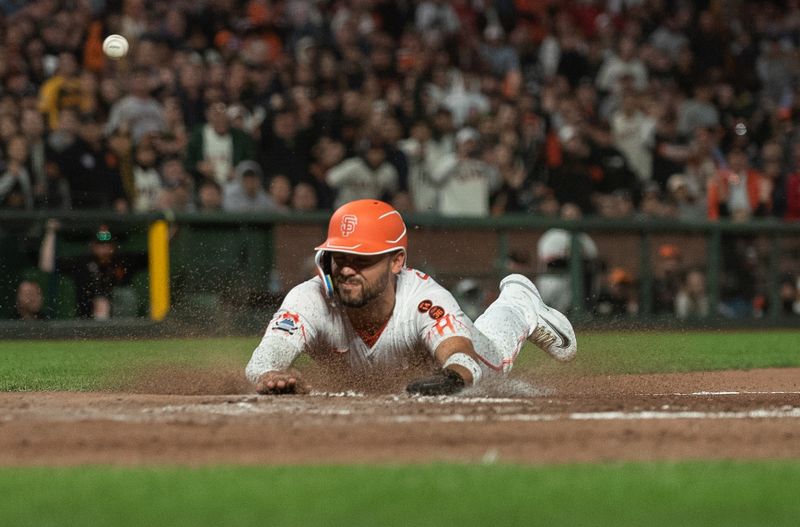 Aug 15, 2023; San Francisco, California, USA;  San Francisco Giants right fielder Michael Conforto (8) slides into home plate during the eighth inning against the Tampa Bay Rays at Oracle Park. Mandatory Credit: Ed Szczepanski-USA TODAY Sports