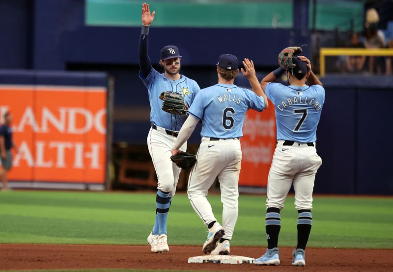 Jul 14, 2024; St. Petersburg, Florida, USA; Tampa Bay Rays outfielder Josh Lowe (15), shortstop Taylor Walls (6), and shortstop Jose Caballero (7) high five as they beat the Cleveland Guardians at Tropicana Field. Mandatory Credit: Kim Klement Neitzel-USA TODAY Sports