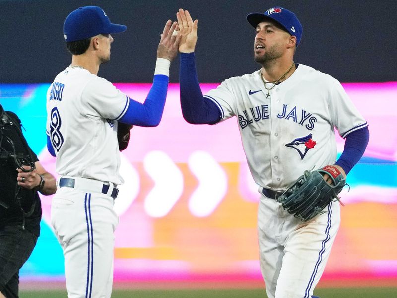 Jun 28, 2023; Toronto, Ontario, CAN; Toronto Blue Jays right fielder George Springer (4) and Toronto Blue Jays second baseman Cavan Biggio (8) celebrate the win against the San Francisco Giants at the end of the ninth inning at Rogers Centre. Mandatory Credit: Nick Turchiaro-USA TODAY Sports