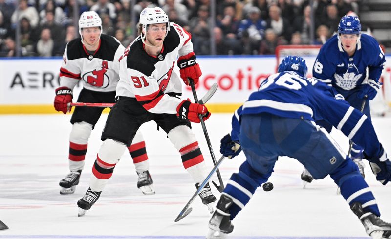 Apr 11, 2024; Toronto, Ontario, CAN; New Jersey Devils forward Dawson Mercer (91) plays the puck against the Toronto Maple Leafs in the second period at Scotiabank Arena. Mandatory Credit: Dan Hamilton-USA TODAY Sports