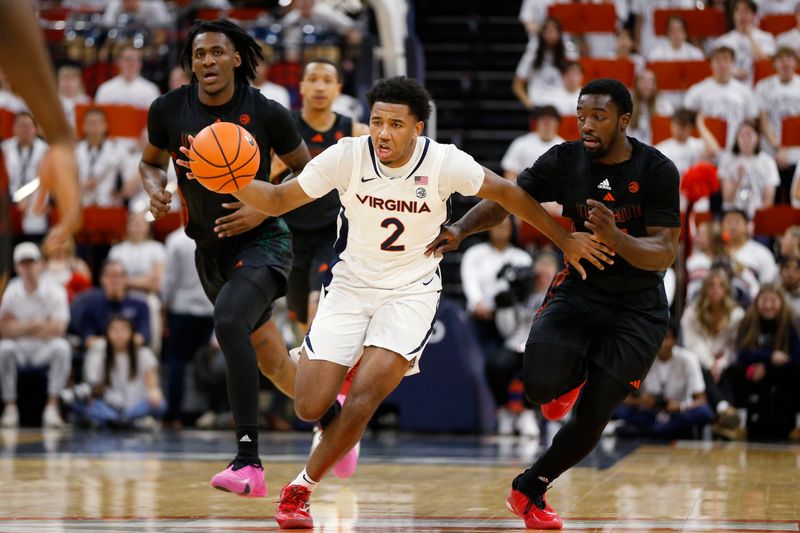 Feb 5, 2024; Charlottesville, Virginia, USA; Virginia Cavaliers guard Reece Beekman (2) dribbles the ball away from Miami (Fl) Hurricanes guard Bensley Joseph (4) during the second half at John Paul Jones Arena. Mandatory Credit: Amber Searls-USA TODAY Sports