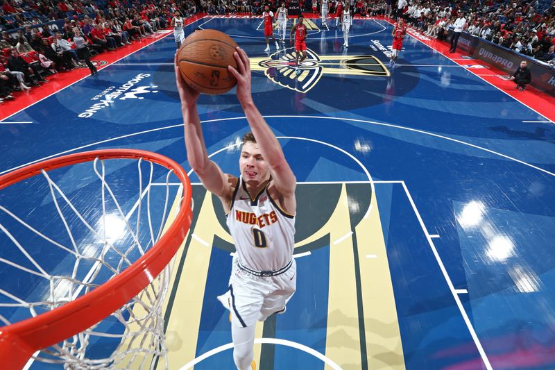 NEW ORLEANS, LA - NOVEMBER 15: Christian Braun #0 of the Denver Nuggets dunks the ball during the game against the New Orleans Pelicans during the Emirates NBA Cup game on November 15, 2024 at the Smoothie King Center in New Orleans, Louisiana. NOTE TO USER: User expressly acknowledges and agrees that, by downloading and or using this Photograph, user is consenting to the terms and conditions of the Getty Images License Agreement. Mandatory Copyright Notice: Copyright 2024 NBAE (Photo by Layne Murdoch Jr./NBAE via Getty Images)