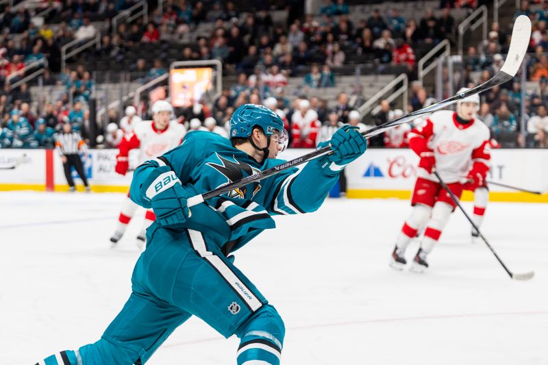 Nov 18, 2024; San Jose, California, USA; San Jose Sharks center Klim Kostin (10) shoots a slap shot during the third period against the Detroit Red Wings at SAP Center at San Jose. Mandatory Credit: Bob Kupbens-Imagn Images